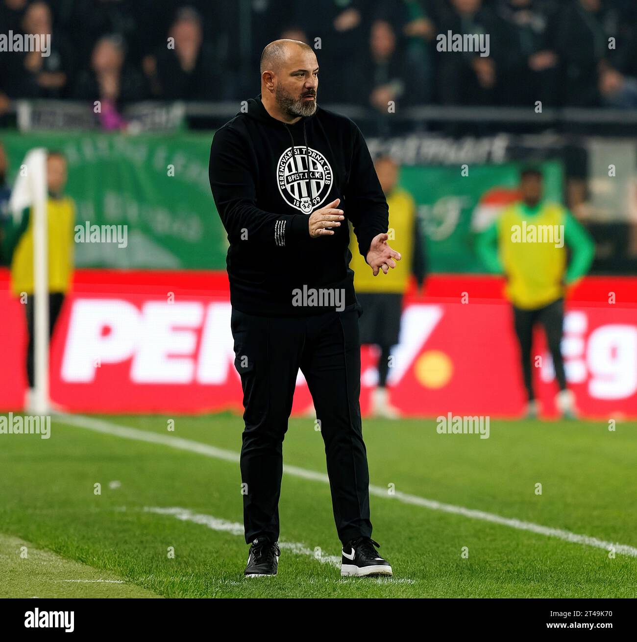 Ultra supporters of Ferencvarosi TC lift scarves over their heads