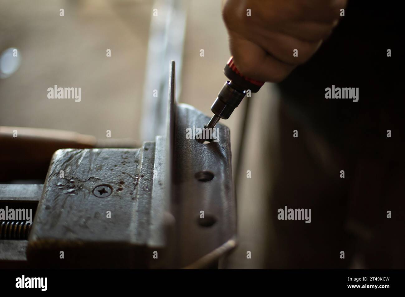 Grinding holes in steel. Removal of excess metal. Create steel part. Hand tools. Hand holds