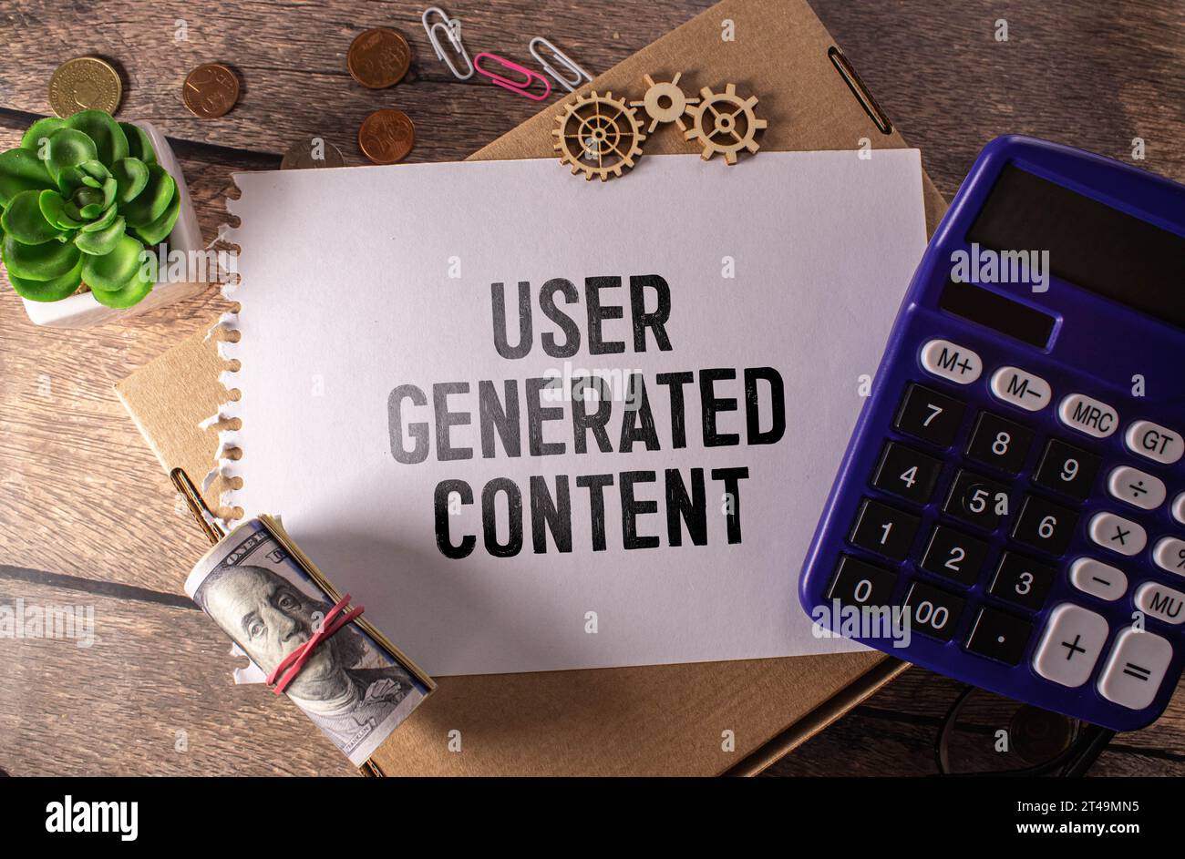 Business concept. Top view of pen,glasses and notebook written with User Generated Content. Stock Photo