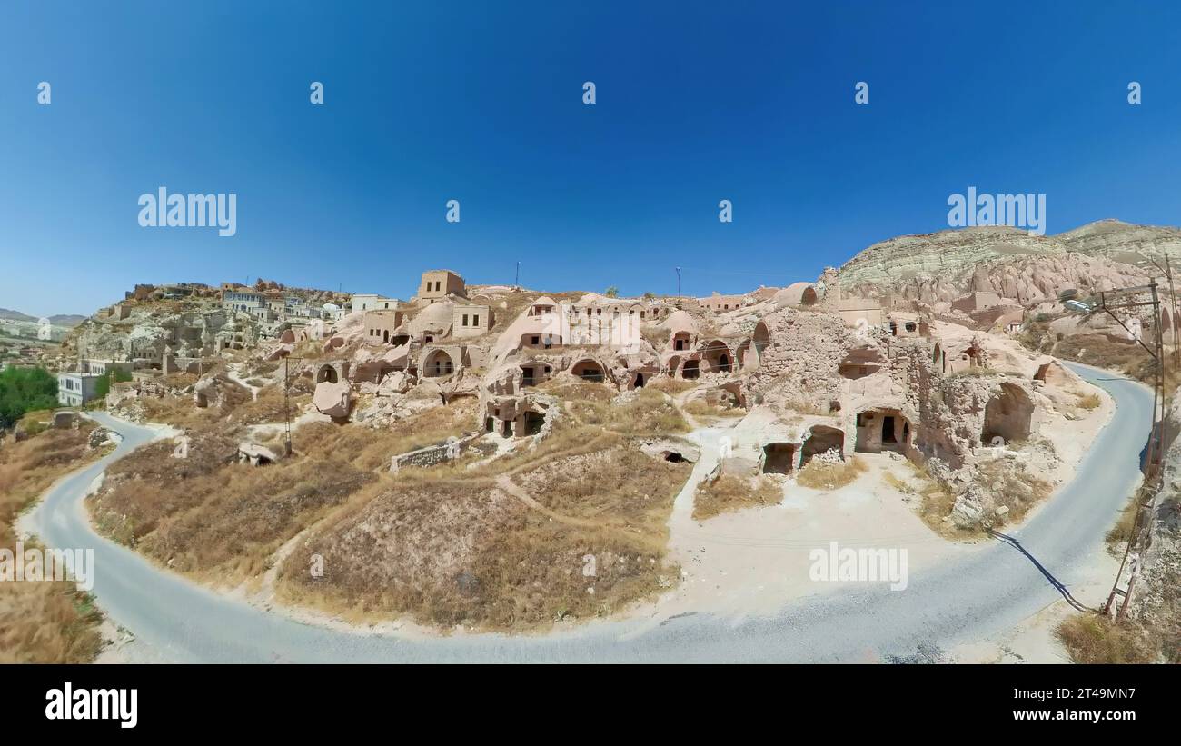 Cavusin village in Cappadocia, Turkey, is a charming blend of ancient heritage and natural beauty. Carved into the rocky hills, the village features Stock Photo