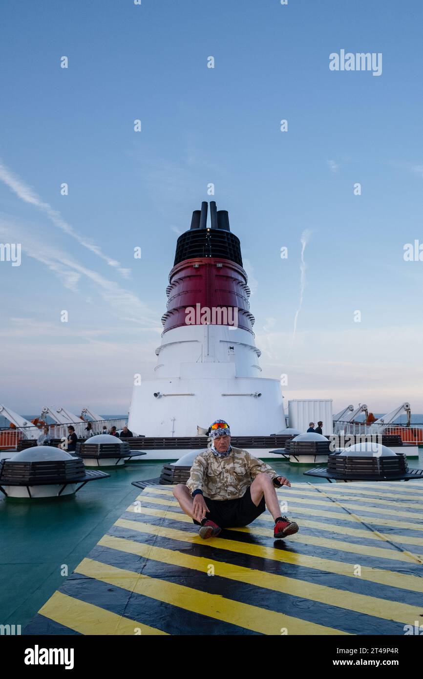 A senior man exercises on a cruise ferry ship travelling on a Baltic Sea cruise between Helsinki in Finland, Åland and Stockholm in Sweden. Stock Photo