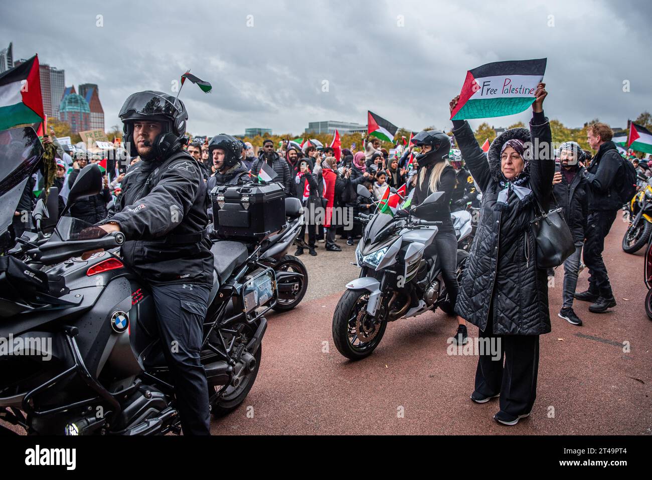 The Hague, South Holland, Netherlands. 29th Oct, 2023. A demonstrator holds a Free Palestine sign while standing near a pro-Palestine motorcycle club. On October 29, 2023, thousands of pro-Palestinian demonstrators gathered at the Malieveld in The Hague to protest against increased Israeli violence in Gaza. The demonstrators followed this by marching through the city to the Peace Palace. (Credit Image: © James Petermeier/ZUMA Press Wire) EDITORIAL USAGE ONLY! Not for Commercial USAGE! Credit: ZUMA Press, Inc./Alamy Live News Stock Photo