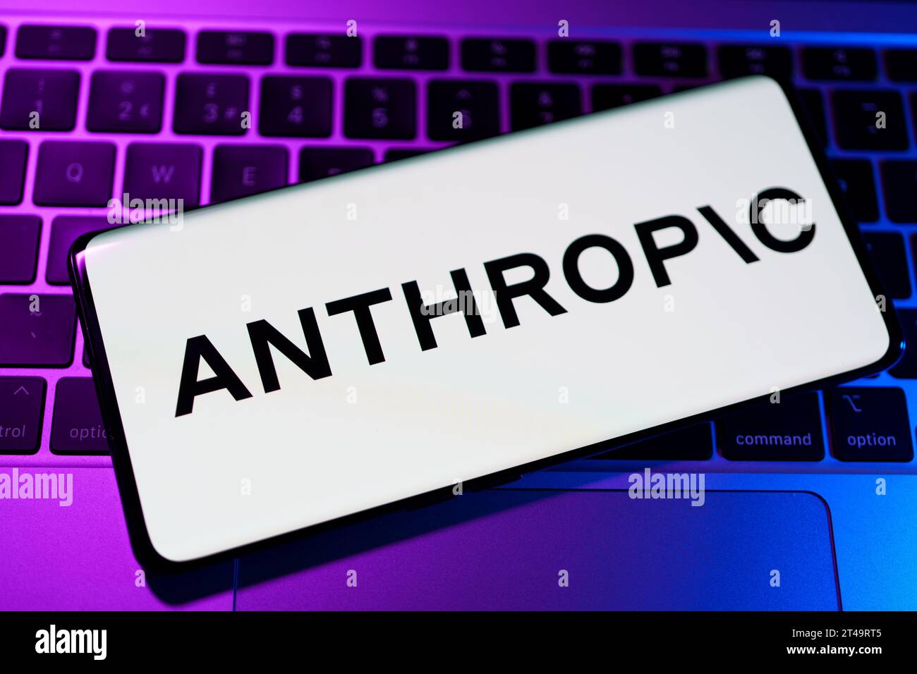 Anthropic AI research company logo seen on the smartphone wich is placed on laptop.  Stafford, United Kingdom, October 29, 2023 Stock Photo