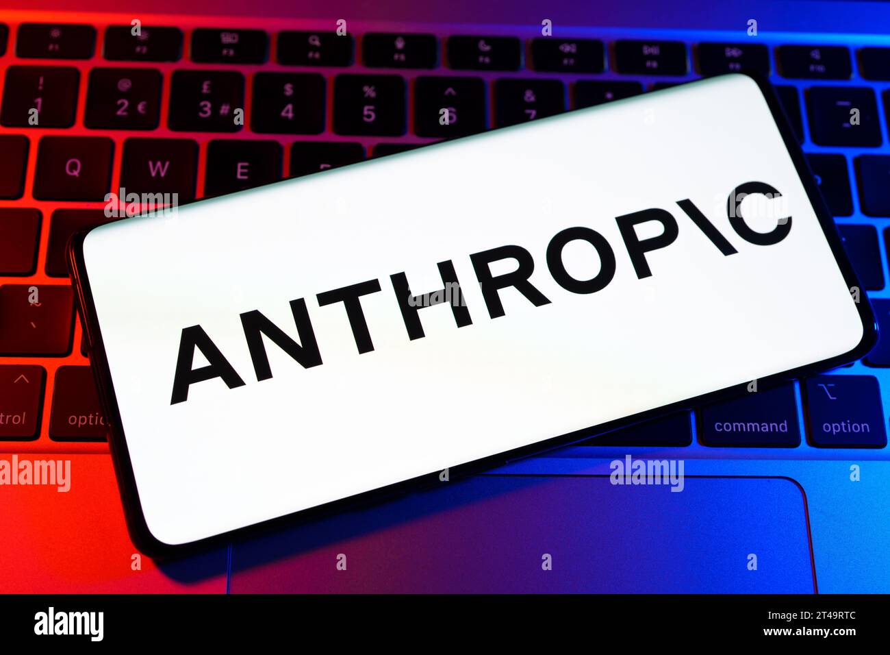 Anthropic AI research company logo seen on the smartphone wich is placed on laptop.  Stafford, United Kingdom, October 29, 2023 Stock Photo