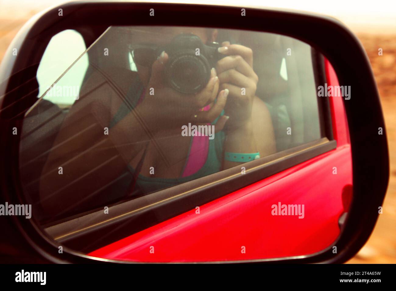 Portrait In Rear View Mirror camera self-portrait through the rearview mirror of a red vehicle Stock ...
