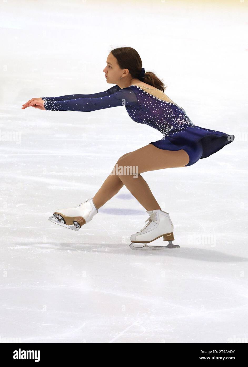 Teenager girl practicing figure skating on an indoor ice skating rink Stock Photo