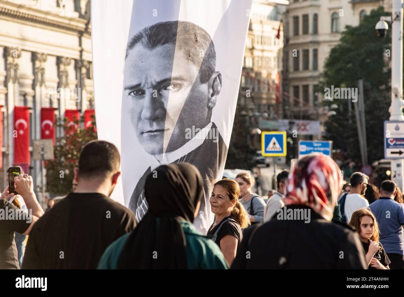 Istanbul, Turkey. 29th Oct, 2023. A woman poses with a portrait of Mustafa Kemal Ataturk in Taksim Square, Istanbul, on the 100th anniversary of the founding of the Republic of Turkey. Credit: SOPA Images Limited/Alamy Live News Stock Photo