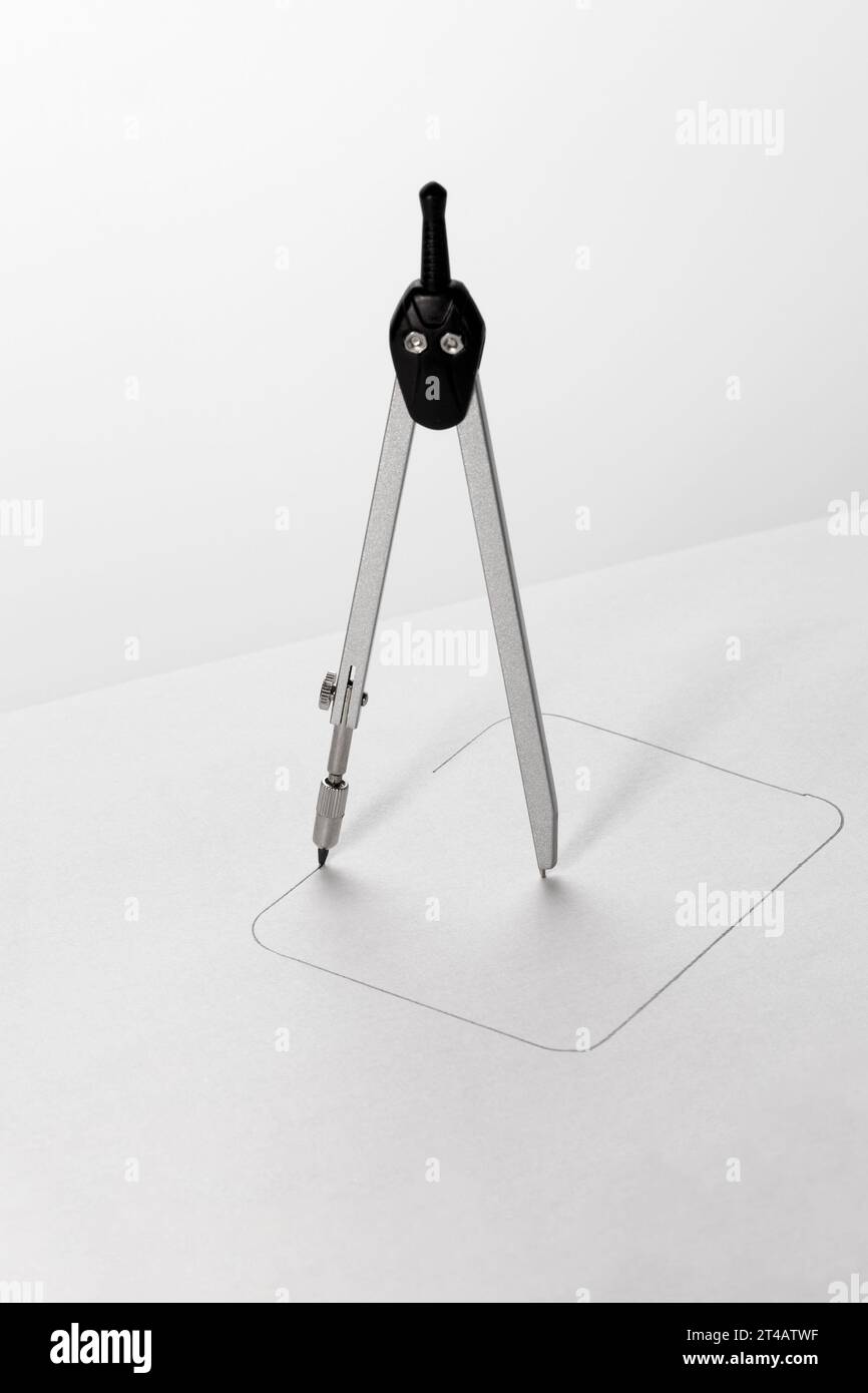 Using a compass, a square is drawn on paper. Impossible concept. Stock Photo