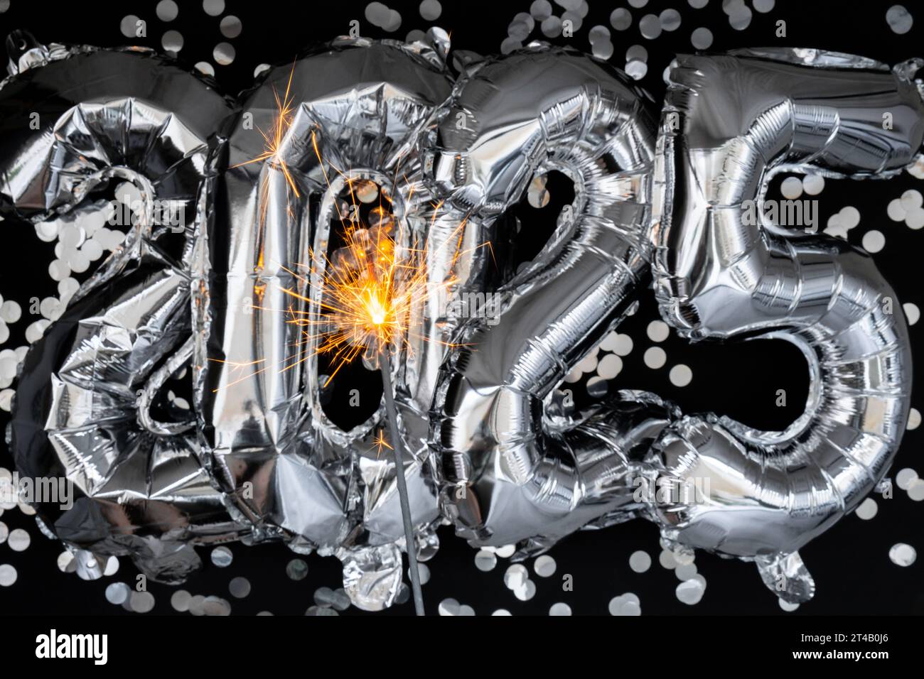 Happy new year 2025 metallic balloons with confetti and sparkler