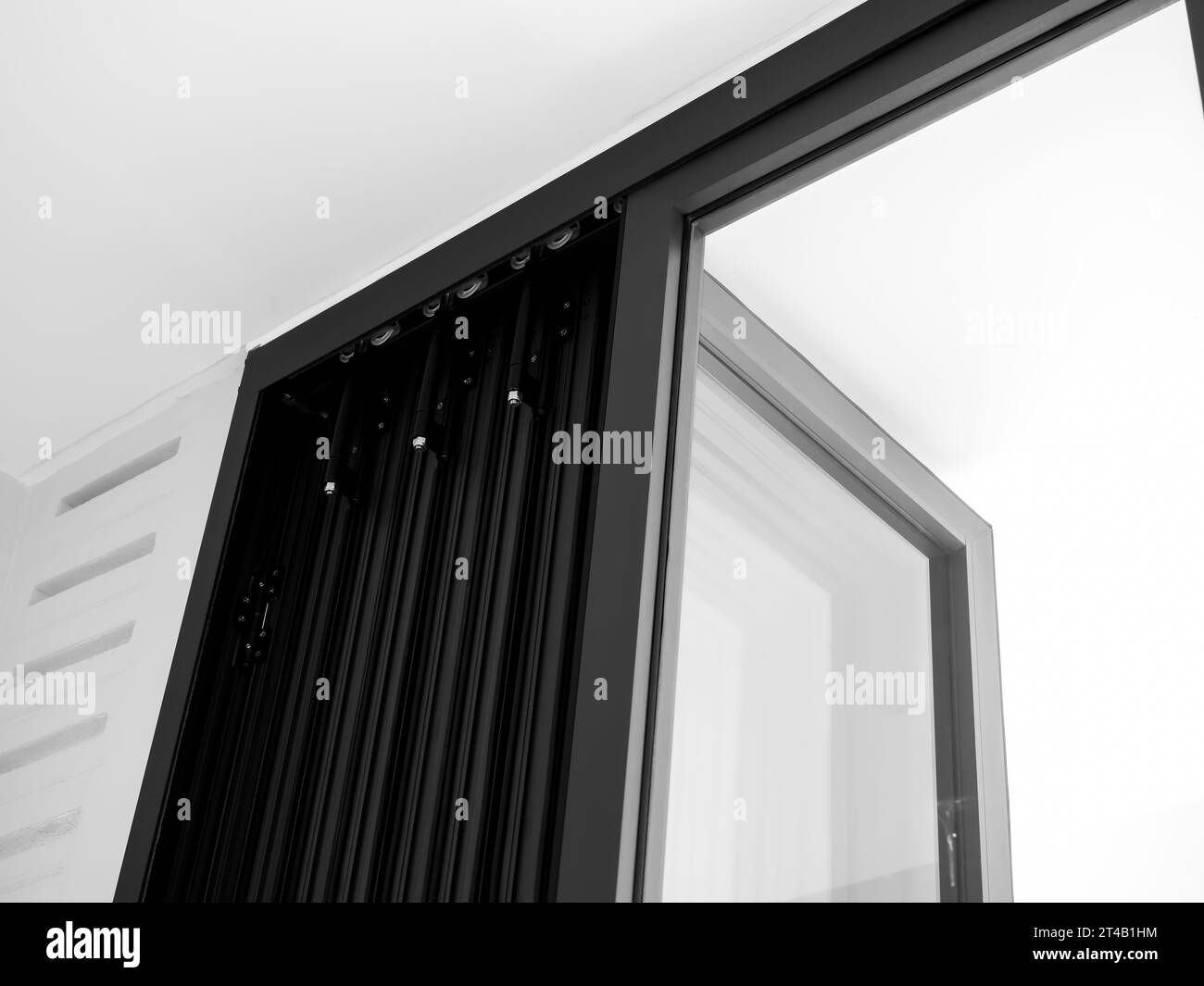 Closeup door hinges on the black aluminum folding doors with glass on