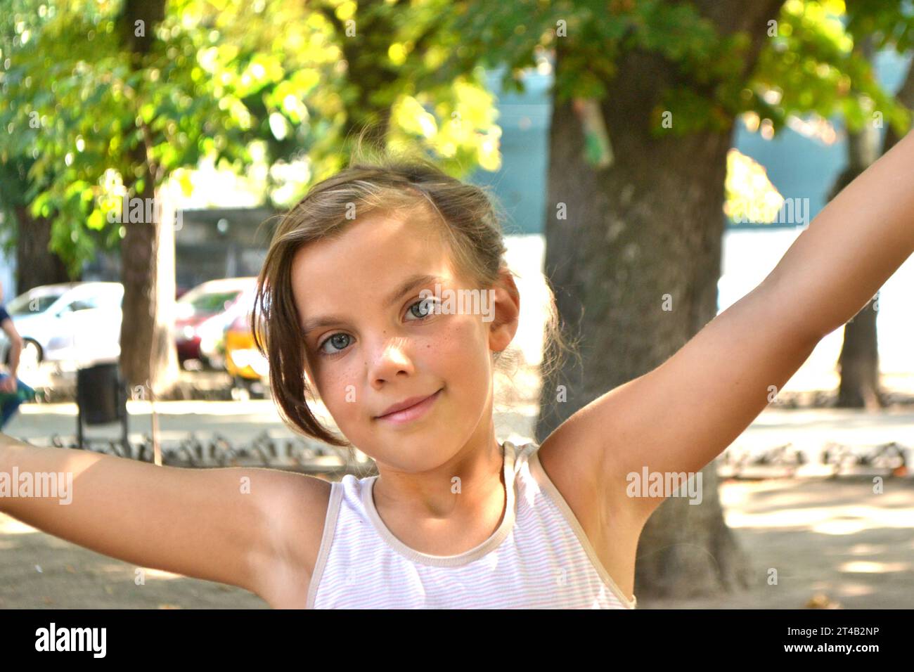 Cute kid girl 10 year old posing on nature background. Looking at camera. Childhood.Blonde girl emotions. High quality photo Stock Photo