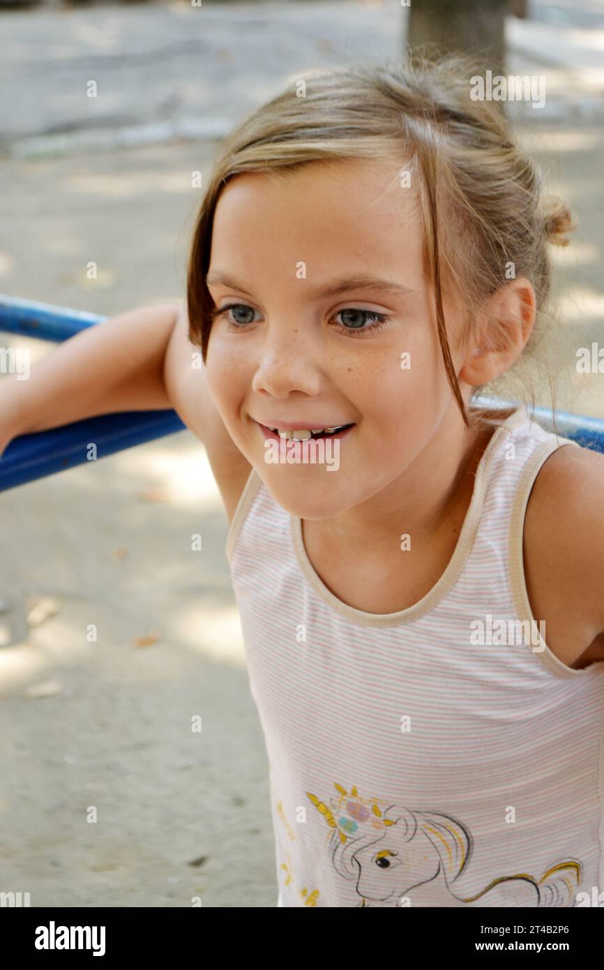 The girl goes in for sports on the Playground on the street. exercises, stretching, exercises. Healthy lifestyle. Fitness training. Workout. Girl goes Stock Photo