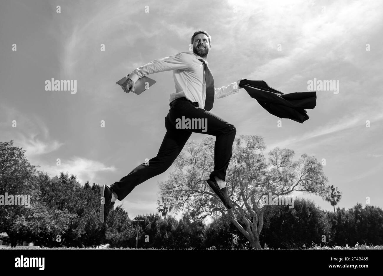 Excited business man running fast, racing and jumping. Portrait of