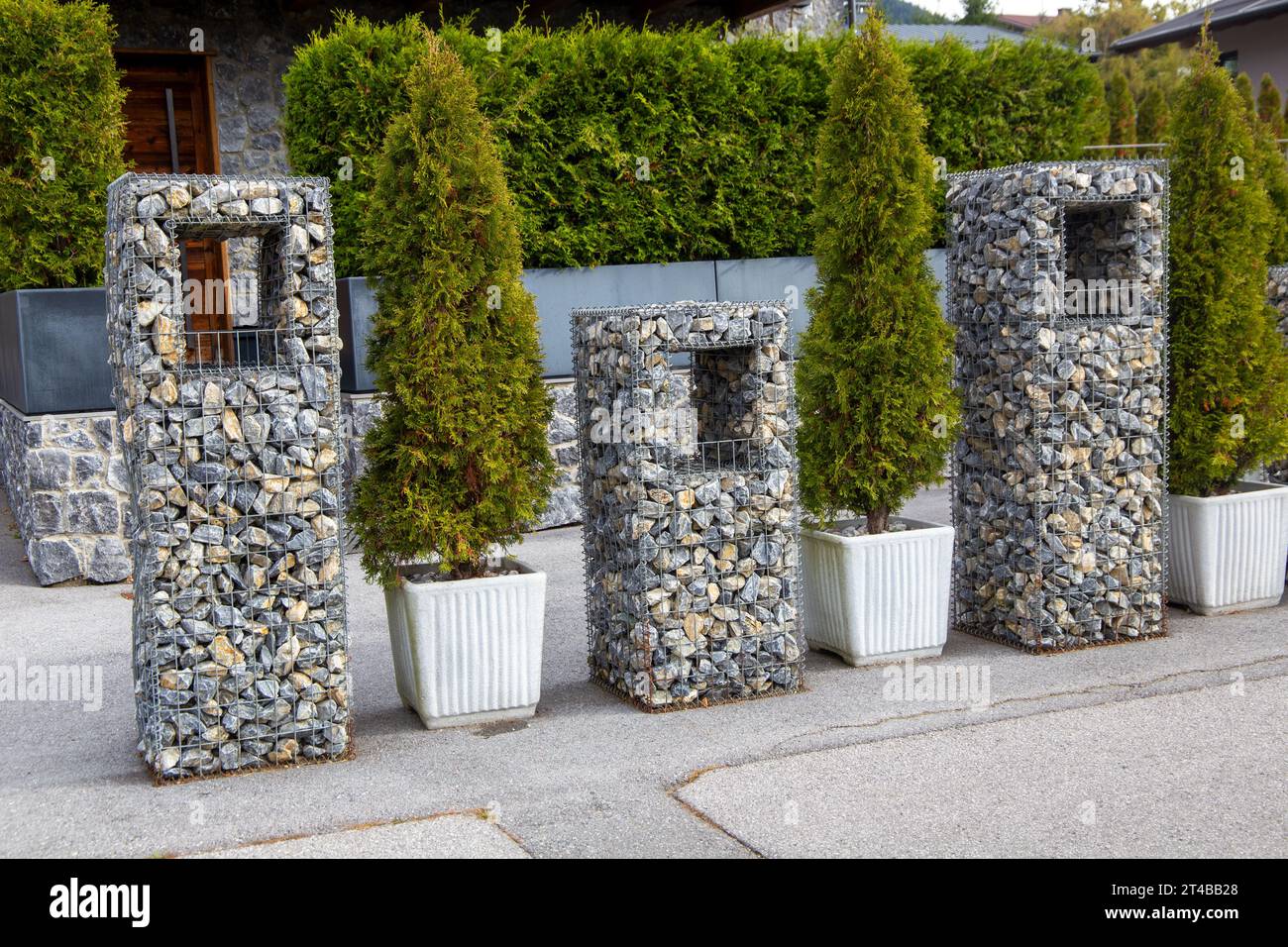 Ornamental gabions or stone baskets as an eyecatcher in front of a new