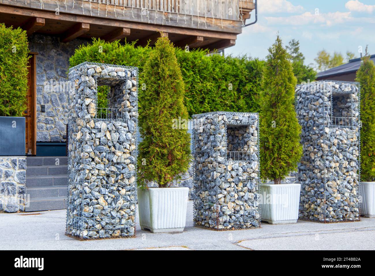 Ornamental gabions or stone baskets as an eyecatcher in front of a new