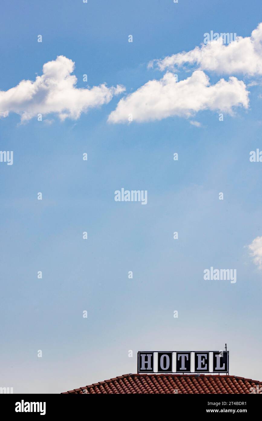 Roof of a hotel in sunshine against a blue sky with the advertising lettering Hotel, Bari Sardo, Ogliastra, Sardinia, Italy Stock Photo