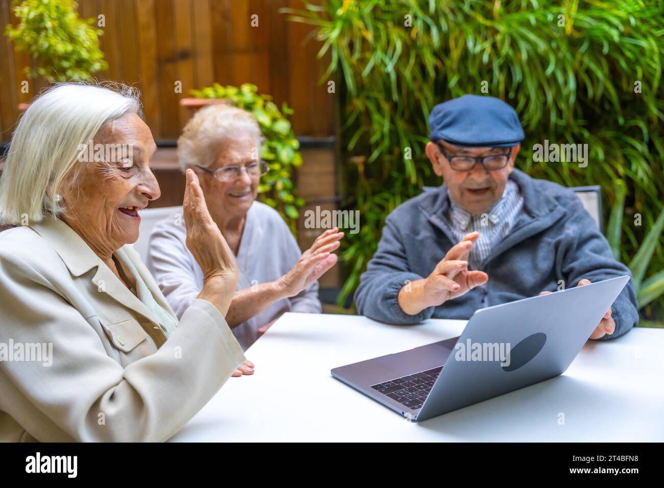 Happy senior people using laptop to have fun in a geriatric Stock Photo