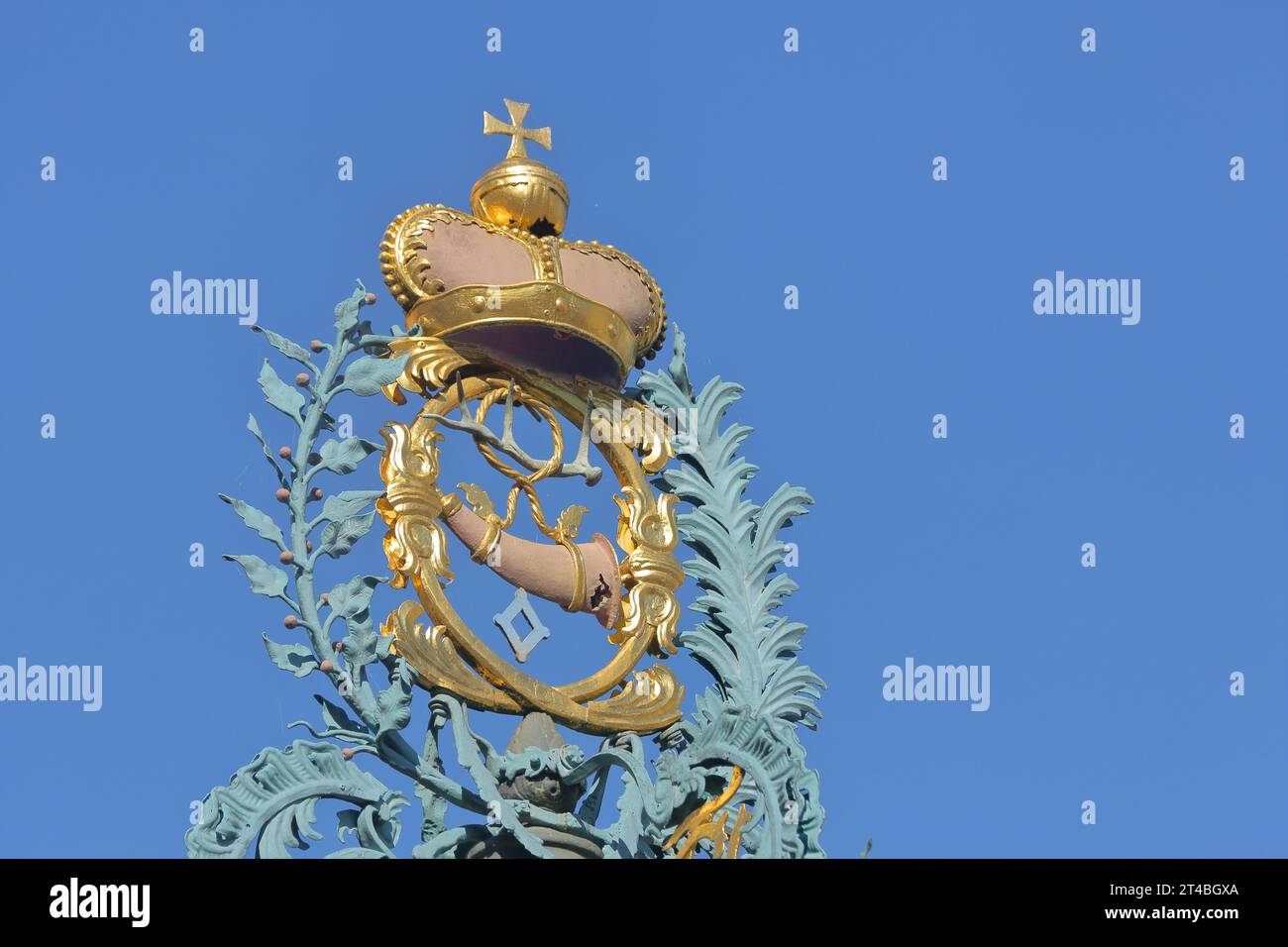 Golden crown with imperial orb and post horn with ornaments at the market fountain, spherical cross, cross, signal horn, wind instrument, golden Stock Photo