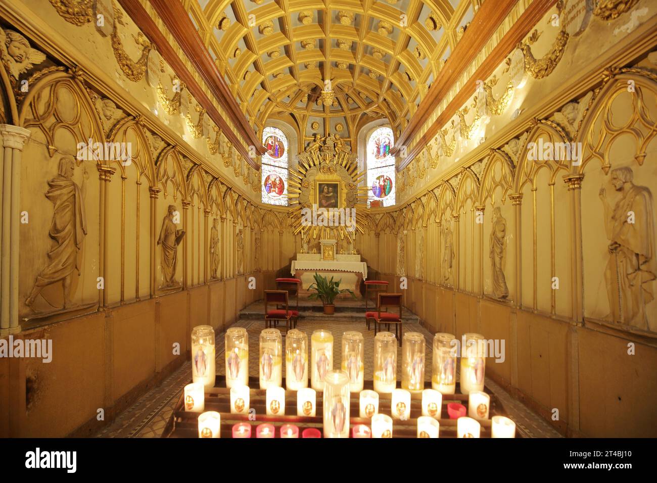Interior view of a side chapel with figures and candle lights of the Romanesque St-Jean Cathedral, St. John's Church, Saint, Romanesque, candles Stock Photo