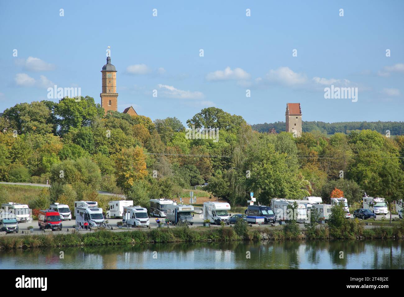 Main bank and car park with motorhomes, cars and church tower of St