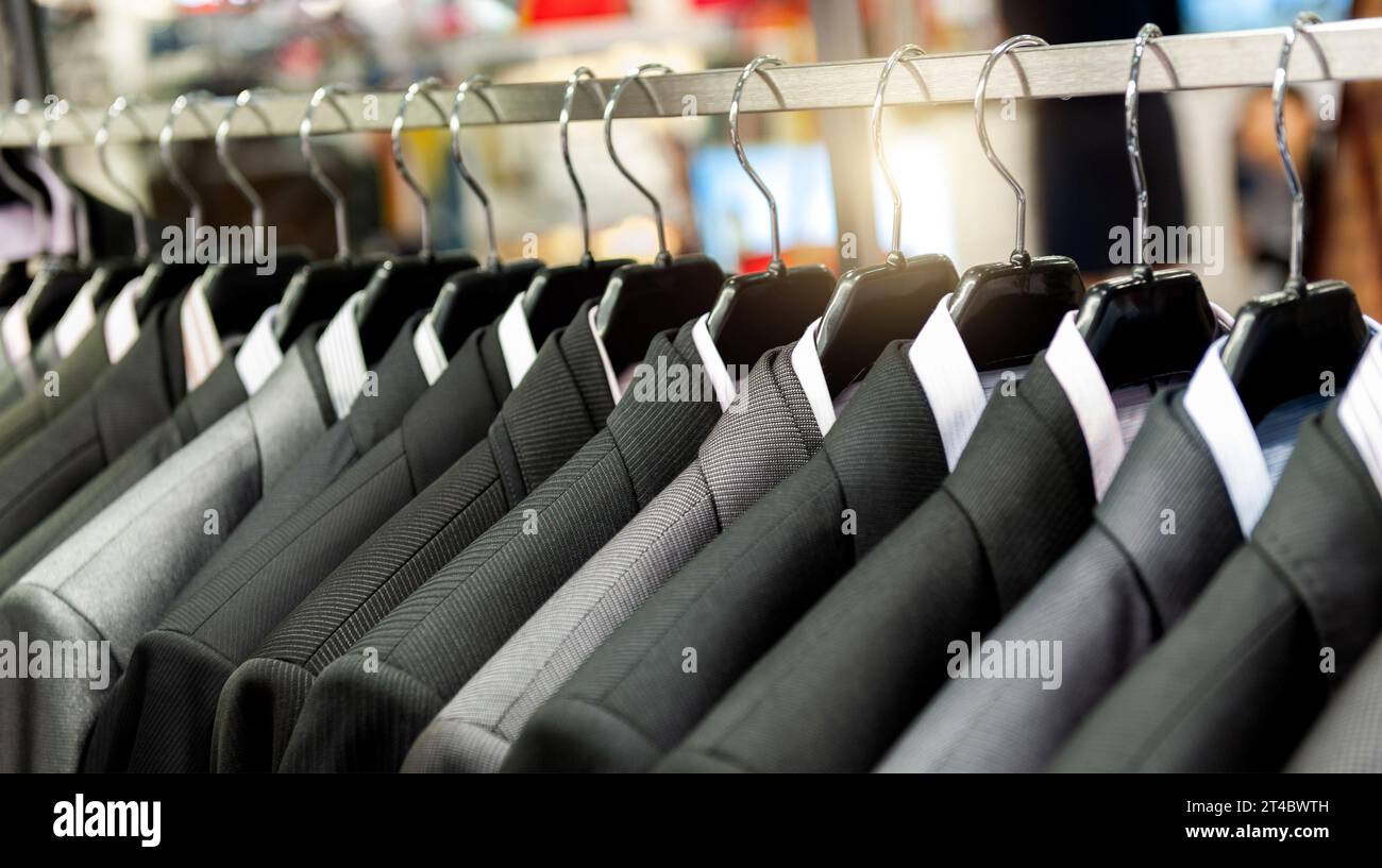 Row of men's suits hanging in closet Stock Photo Alamy