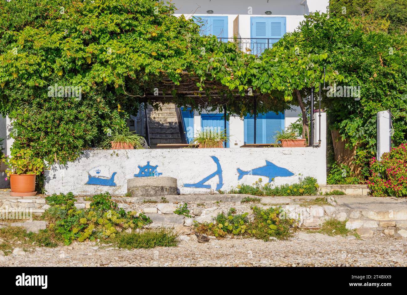 House on the beach with nautical frescos on its wall on the north coast of Corfu Ionian Islands Greece Stock Photo