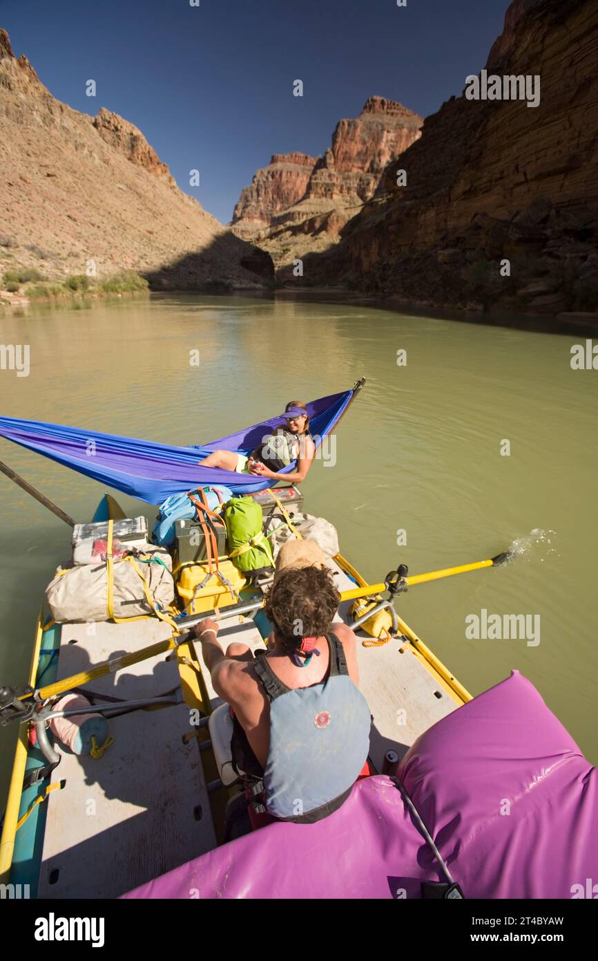 Person Rowing A Raft man rowing raft while woman lays in hammock, Grand Canyon, Arizona ...