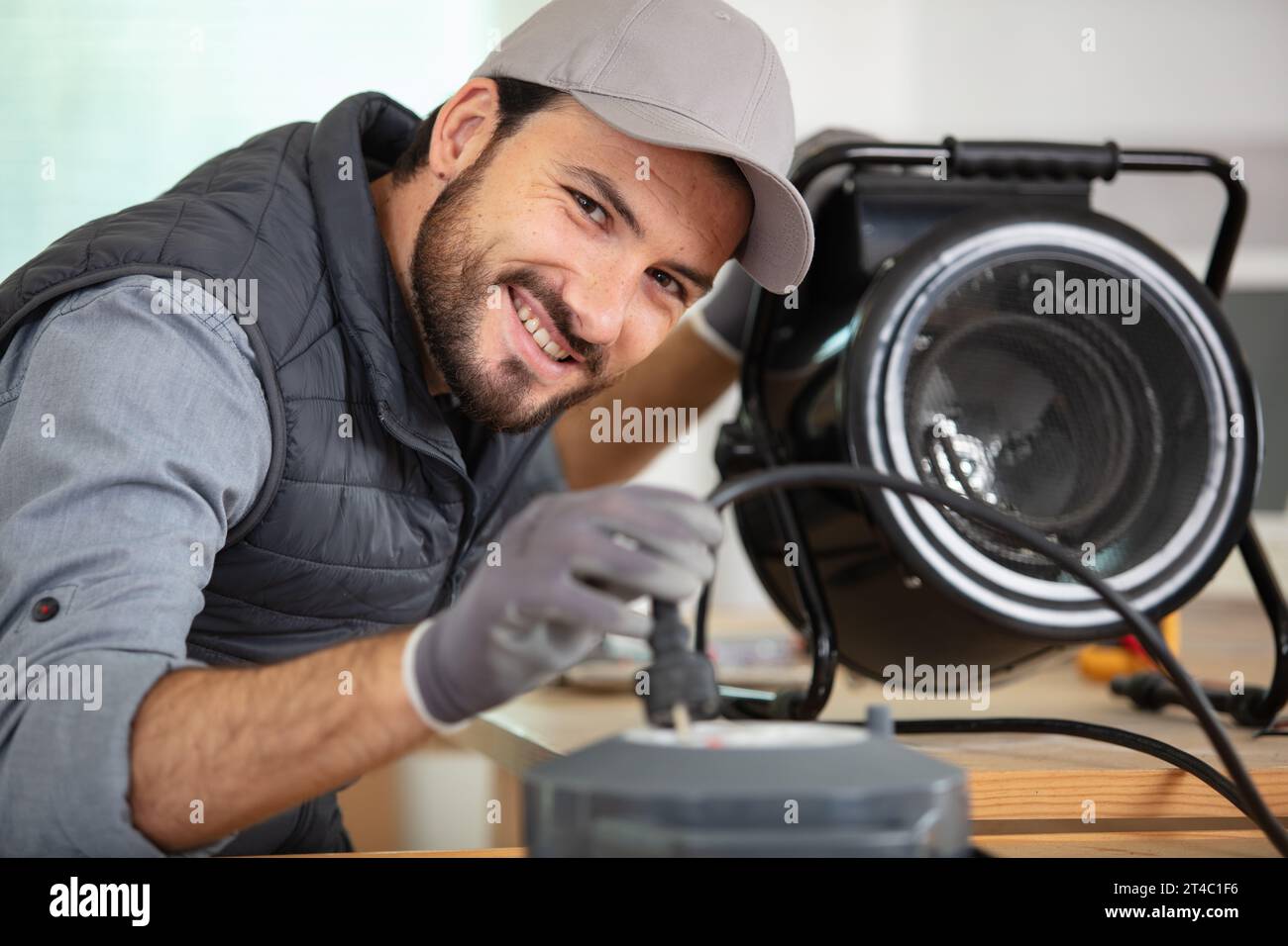young male technician checking appliance Stock Photo