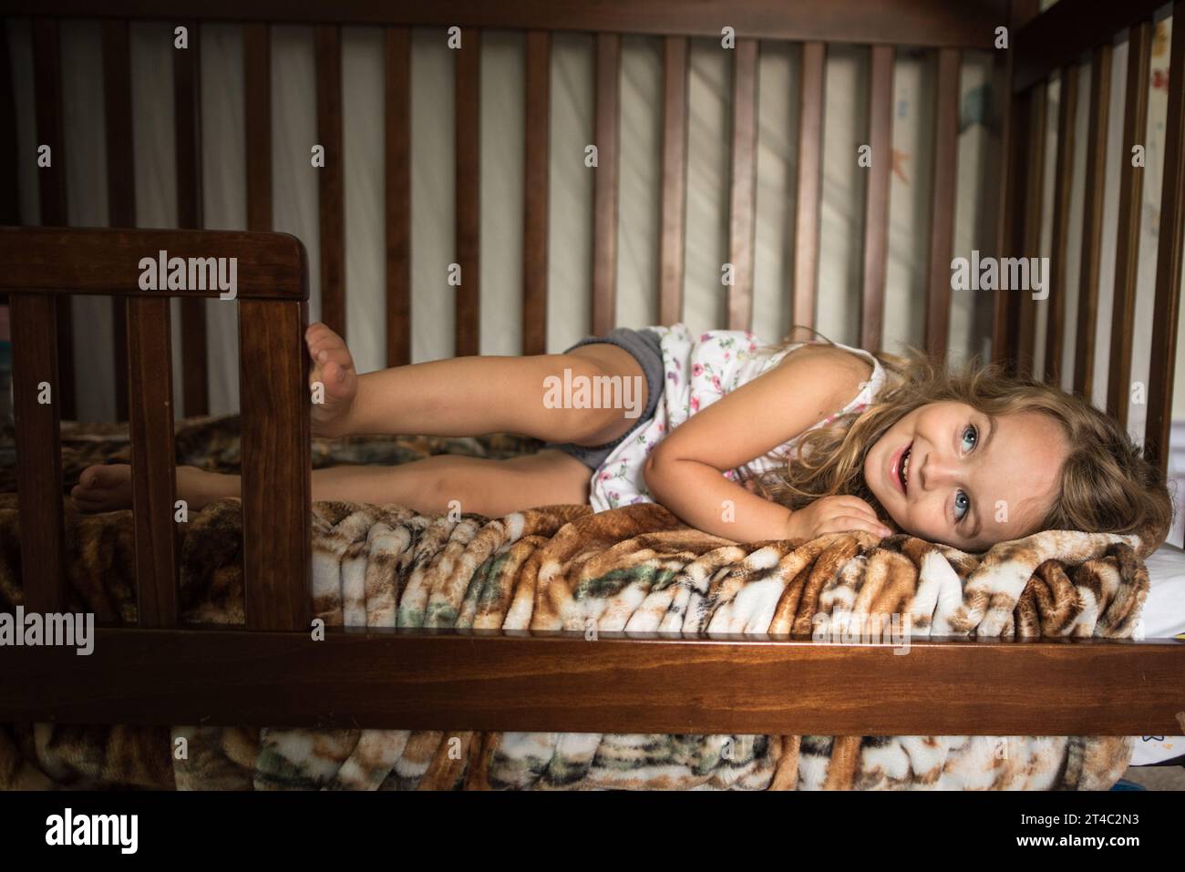Beautiful young girl smiling in bed Stock Photo
