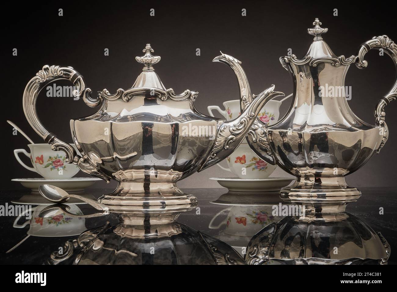 Silver tea set, teacups & silver spoons Stock Photo