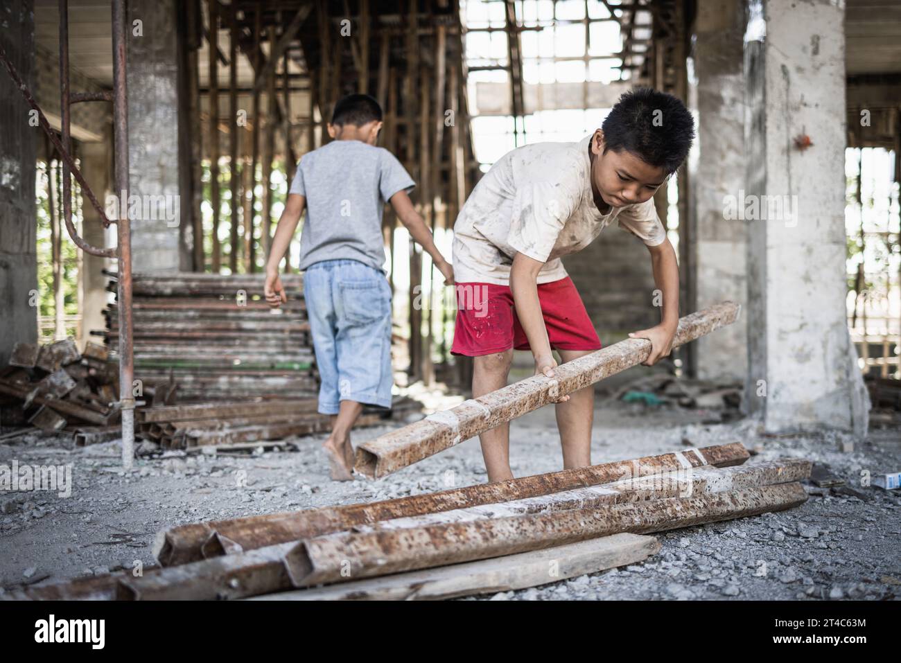 Poor children forced to do construction work, child labor, abuse To the rights of children, victims of human trafficking, World Day Against Child Labo Stock Photo