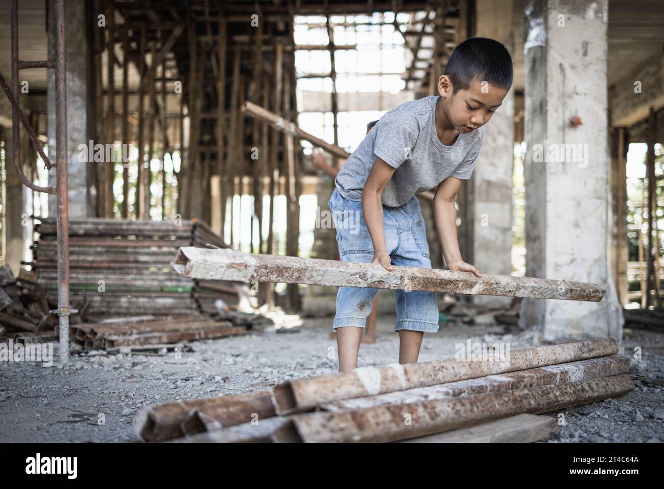 Poor children forced to do construction work, child labor, abuse To the rights of children, victims of human trafficking, World Day Against Child Labo Stock Photo