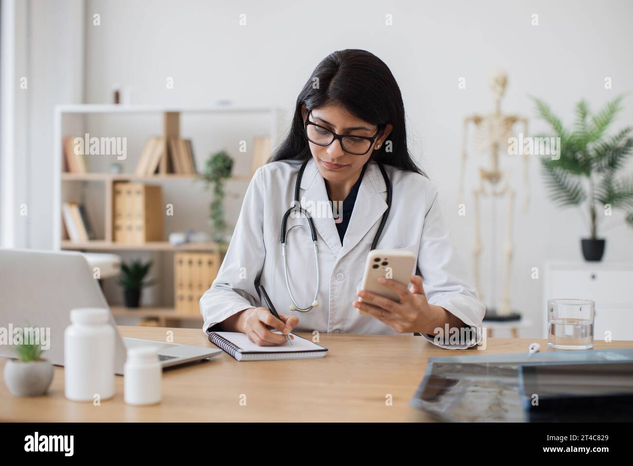Nurse practitioner making notes on a tablet while on a video call