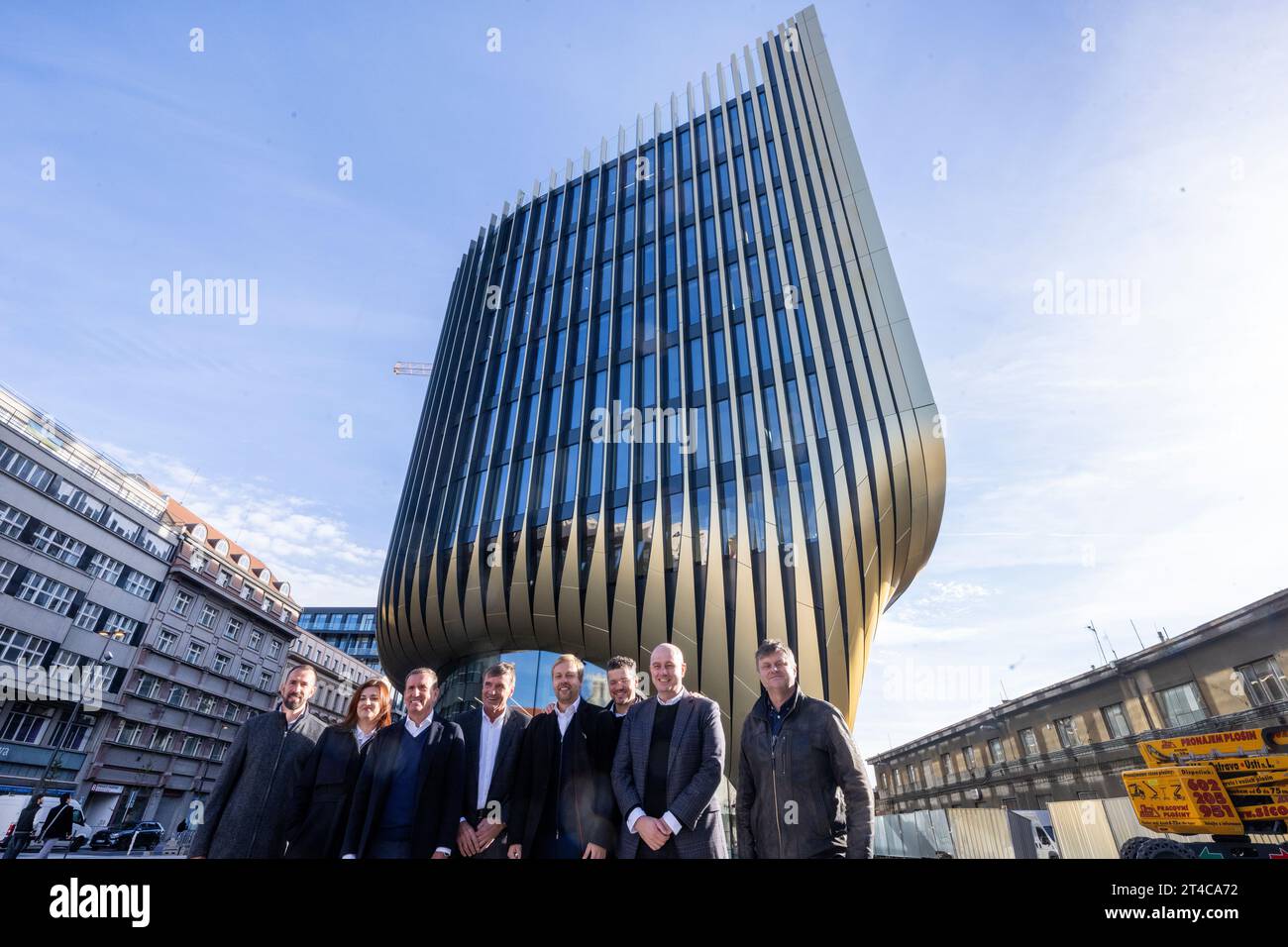 Prague, Czech Republic. 30th Oct, 2023. Co-owner of Penta Marek Dospiva, third from left, and Penta's Managing Director for the Czech Republic Petr Palicka, fourth from left, attend a happening on the occasion of the completion of the golden facade on the western facade of the newmultifunctional building with commercial premises Masarycka pictured on October 30, 2023, in Na Florenci Street near Masaryk Railway Station in Prague, Czech Republic. The architectural design of the building was created by Zaha Hadid Architects. Credit: Michaela Rihova/CTK Photo/Alamy Live News Stock Photo
