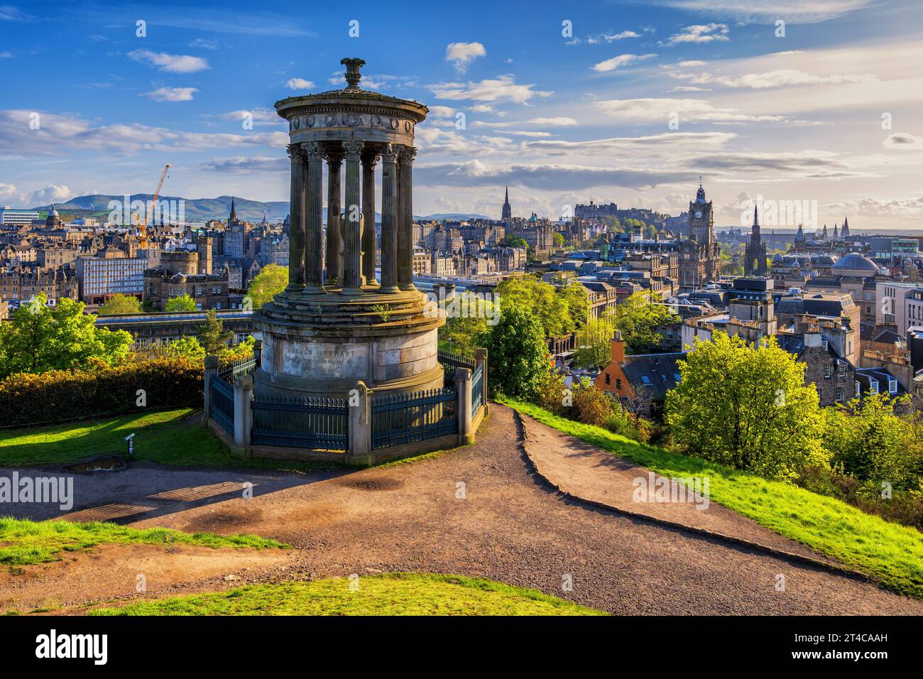 City of Edinburgh at sunset in Scotland, UK. View from the Calton Hill with Dugald Stewart Monument, sunny springtime afternoon. Stock Photo