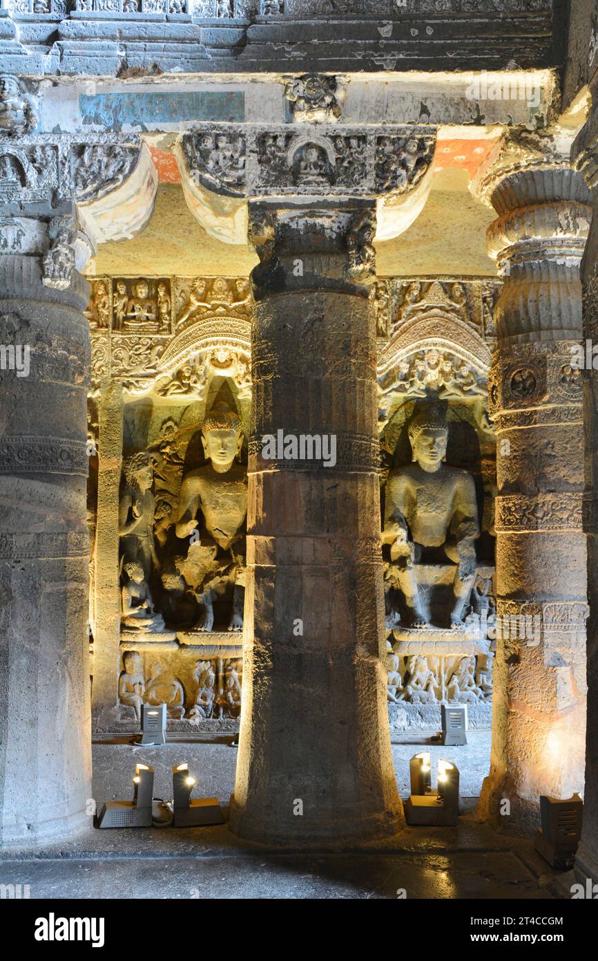 Cave No. 26. Seated life size Buddha images in Pralambapadasana posture in the right aisle.   Ajanta Caves, Aurangabad, Maharashtra, India Stock Photo