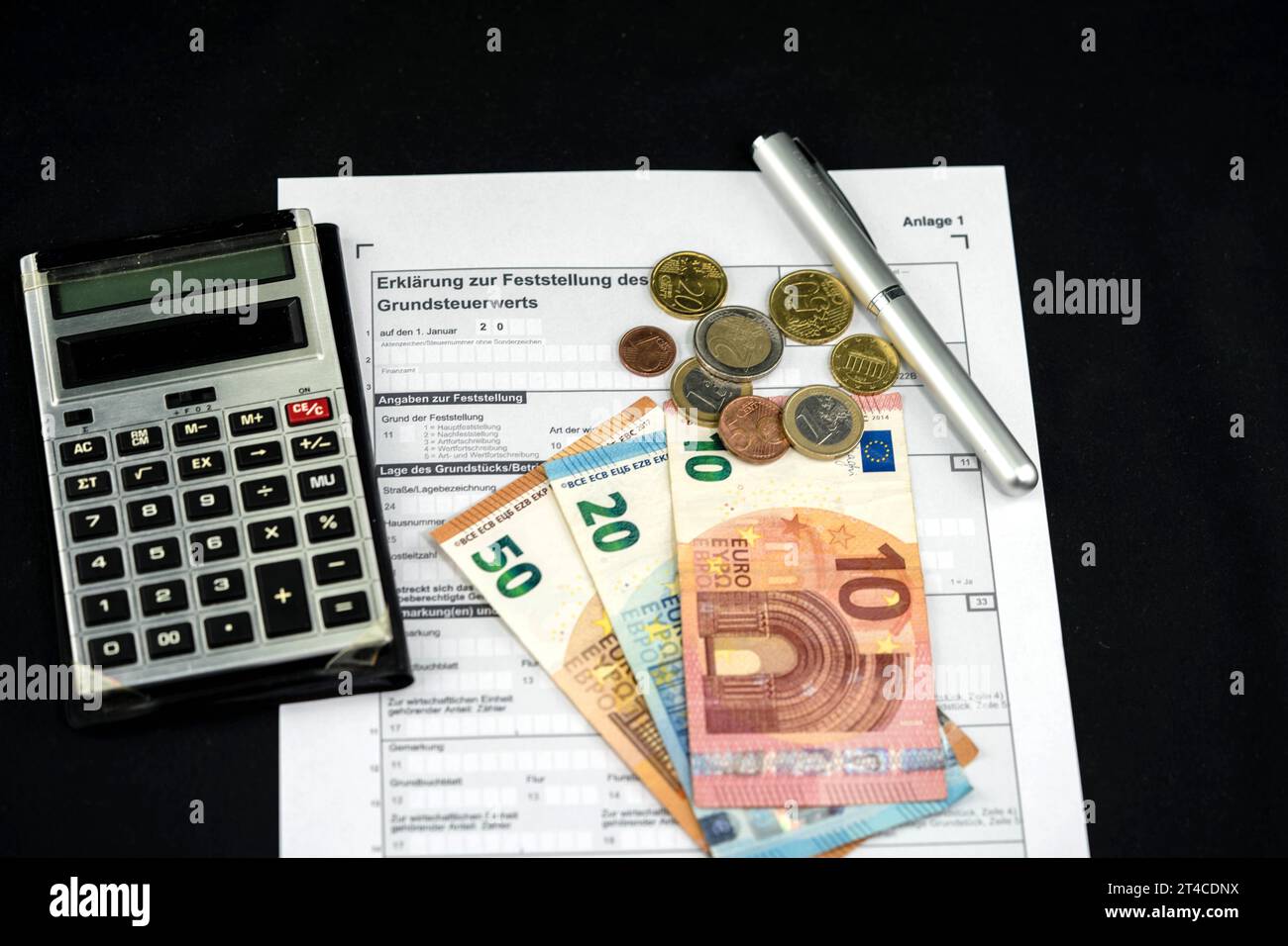 document about land tax with calculator, ballpen and Euros Stock Photo