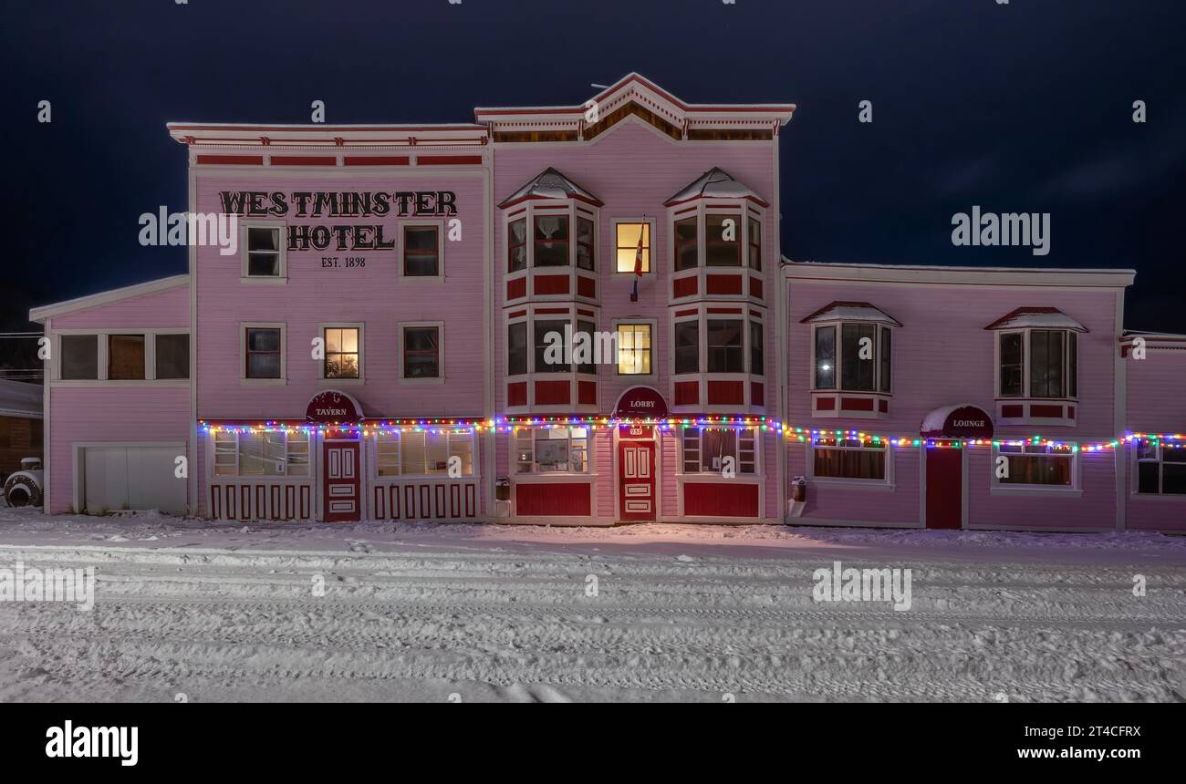 Dawson City, Yukon, Canada – October 06:  Exterior of the Westminster Hotel with a snowy night street Stock Photo