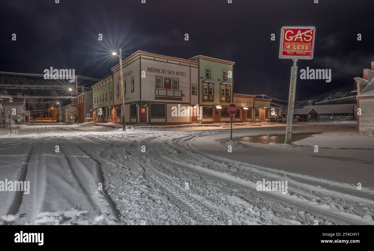 Dawson City, Yukon, Canada – October 06:  Exterior of the Midnight Sun Hotel with a snowy night street Stock Photo