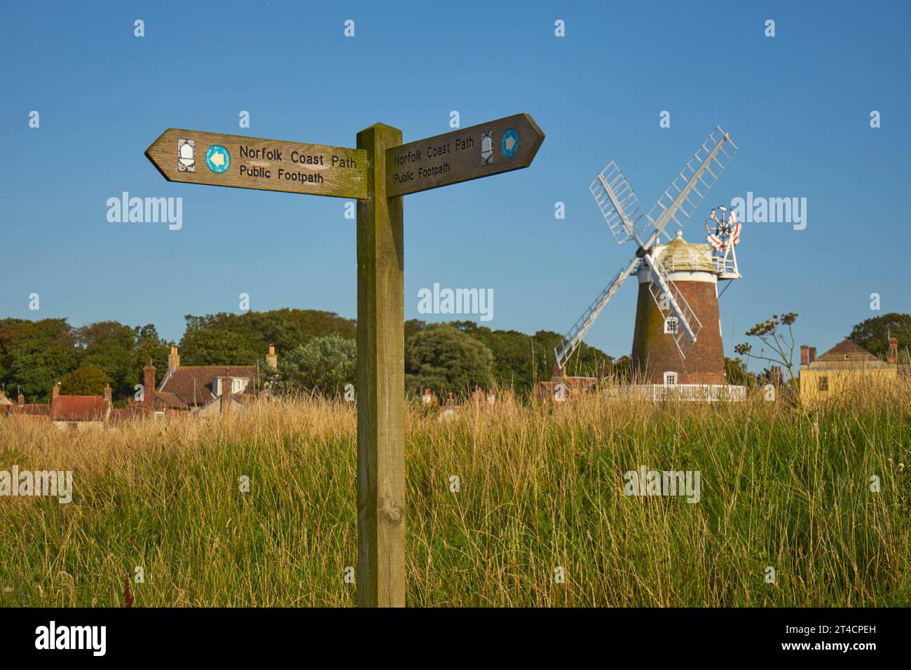 Cley Windmill from Norfolk Coastpath with Coastpath sign, near Blakeney, Norfolk Stock Photo