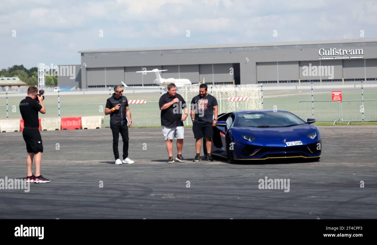 Mike Brewer and David Trigg, showcasing a selection of supercars, in a