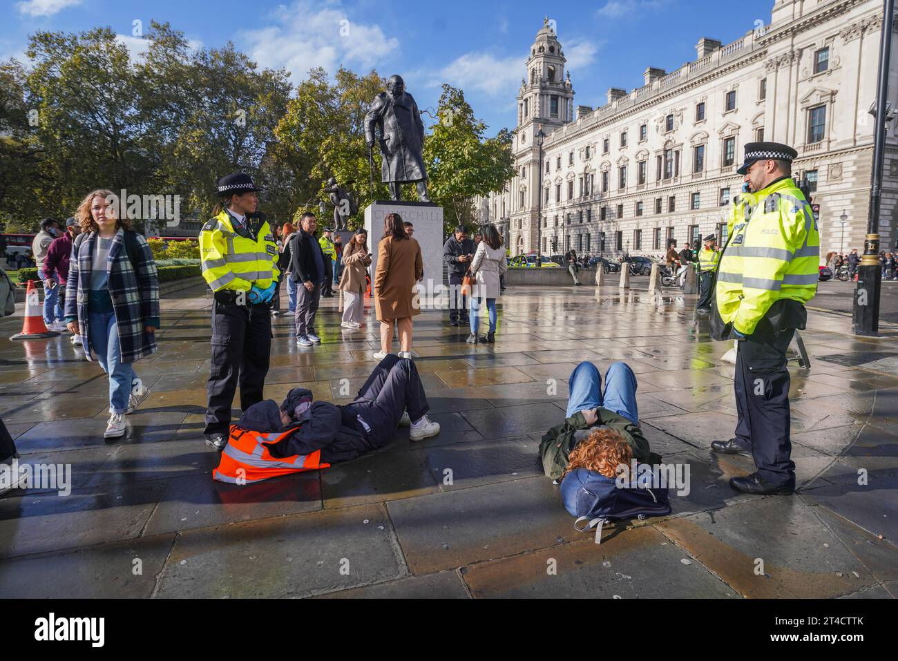 London, UK. 30 October 2023. Just Stop Oil climate activists are arrested and handcuffed by Police after they blocked traffic by ‘slow marching’ outside parliament in Westminster . Just Stop Oil has vowed to carry their campaign of disruption  while new fossil fuel licenses are being granted by the government. Credit amer ghazzal/Alamy Live News Stock Photo