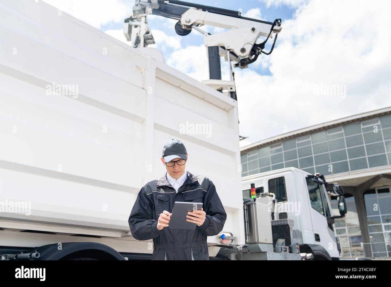 Manager with a digital tablet next to garbage truck.. Stock Photo