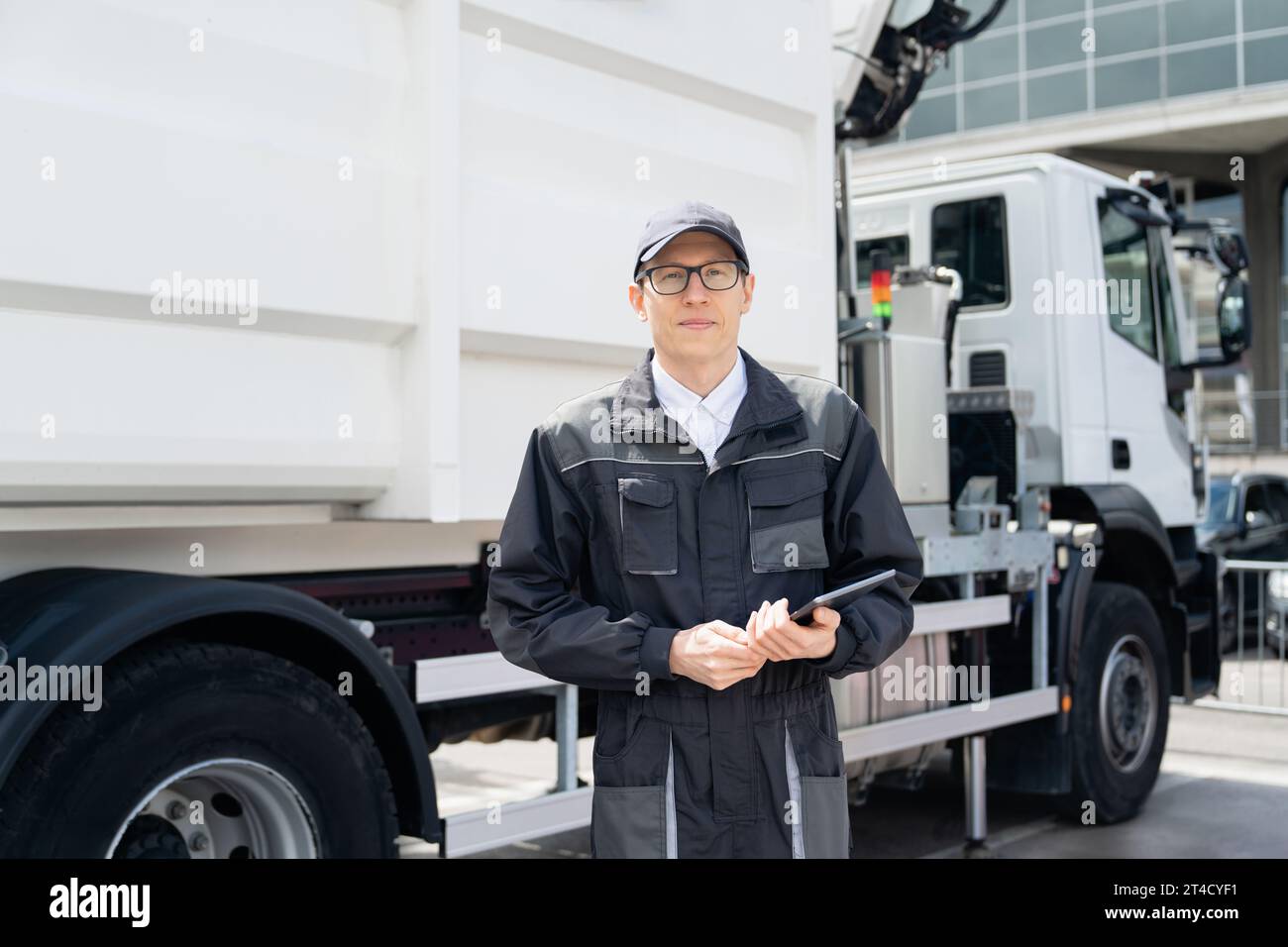 Manager with a digital tablet next to garbage truck.. Stock Photo