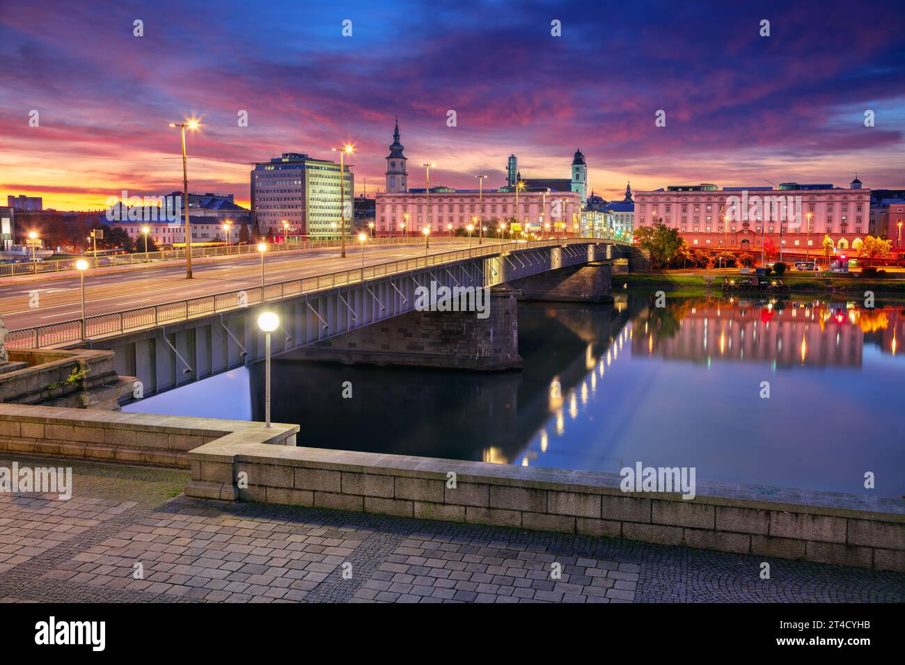 Linz, Austria. Cityscape image of riverside Linz, Austria at autumn sunrise with reflection of the city lights in Danube River. Stock Photo