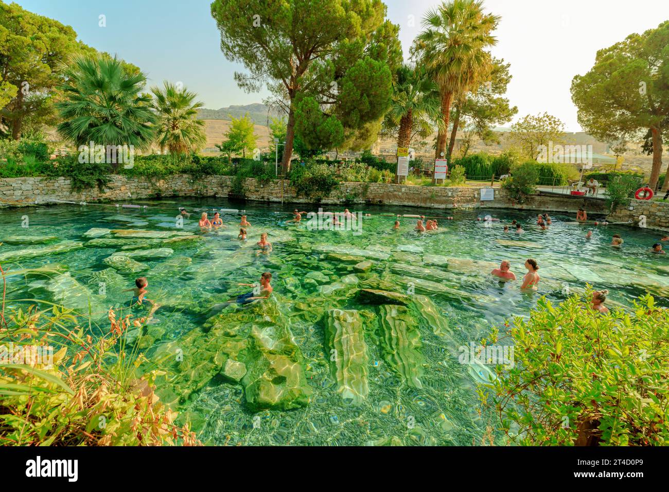Pamukkale, Turkey - Aug 7,2023: people partake in thermal Cleopatra Pools in Hierapolis, Turkey, embracing the restorative encounter amidst the Stock Photo