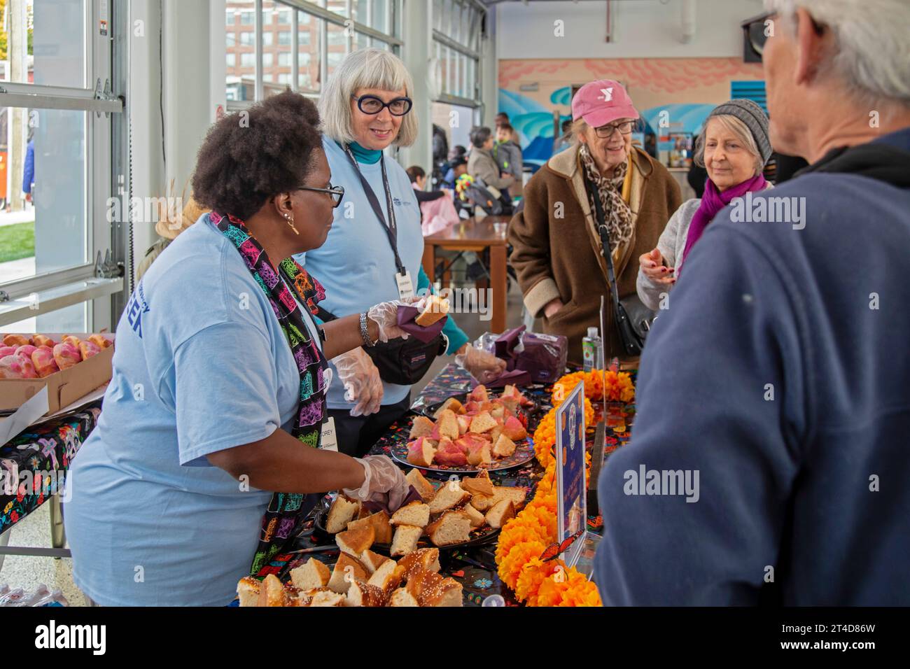 Detroit, Michigan - Day of the Dead celebration at Valade Park on the Detroit Riverfront. Volunteers distributed Pan de Muerto, or bread of the dead. Stock Photo