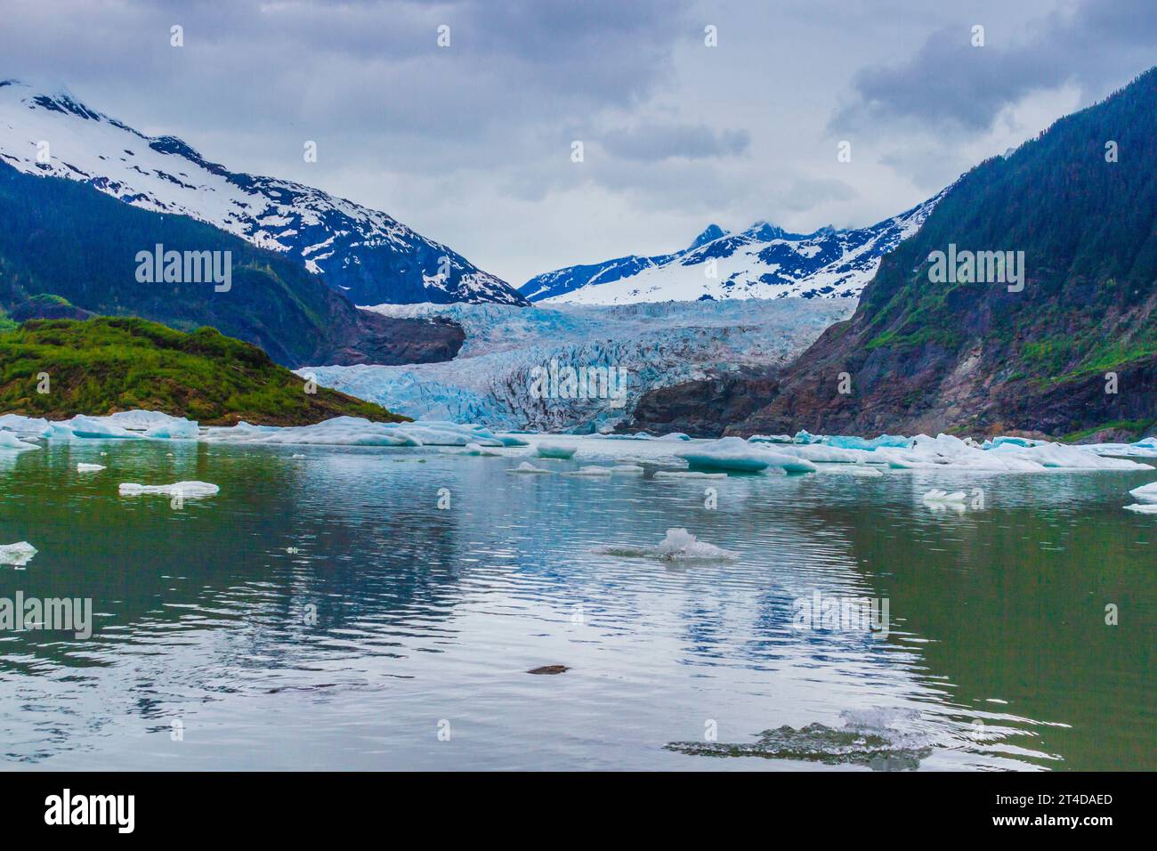 Mendenhall Glacier is about a 12 mile long glacier in Mendenhall Valley, about 12 miles  from downtown Juneau. It is a major tourist attraction. Stock Photo