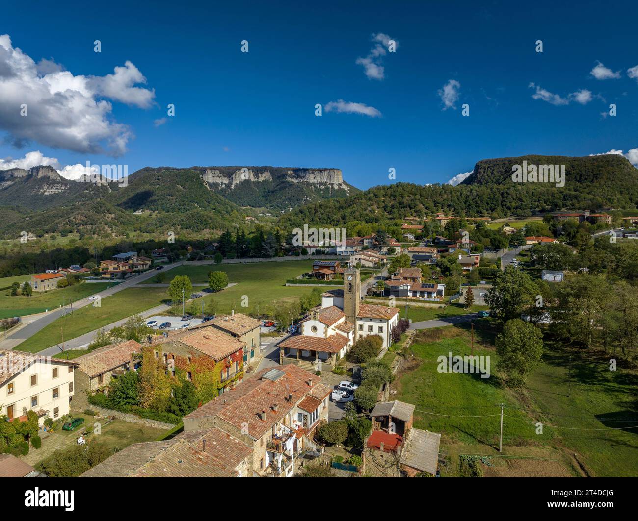 Aerial view of the village of Cantonigròs and the surrounding meadows and cliffs of Collsacabra or Cabrerès (Osona, Barcelona, Catalonia, Spain) Stock Photo