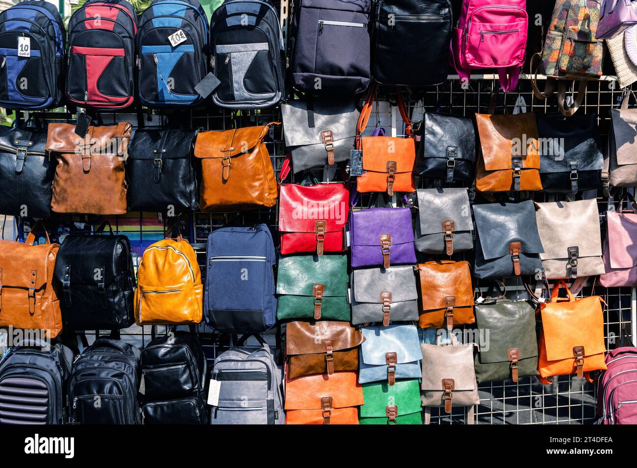 Backpacks and bags, shape and size, on display in a retail store